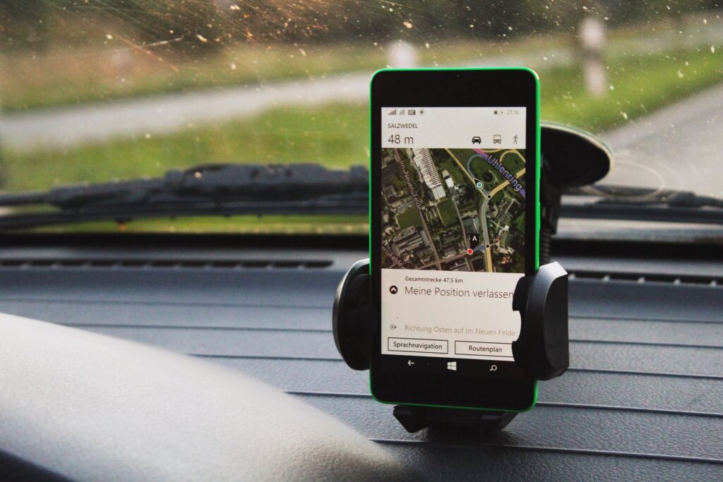 Smartphone showing GPS navigation mounted inside a car